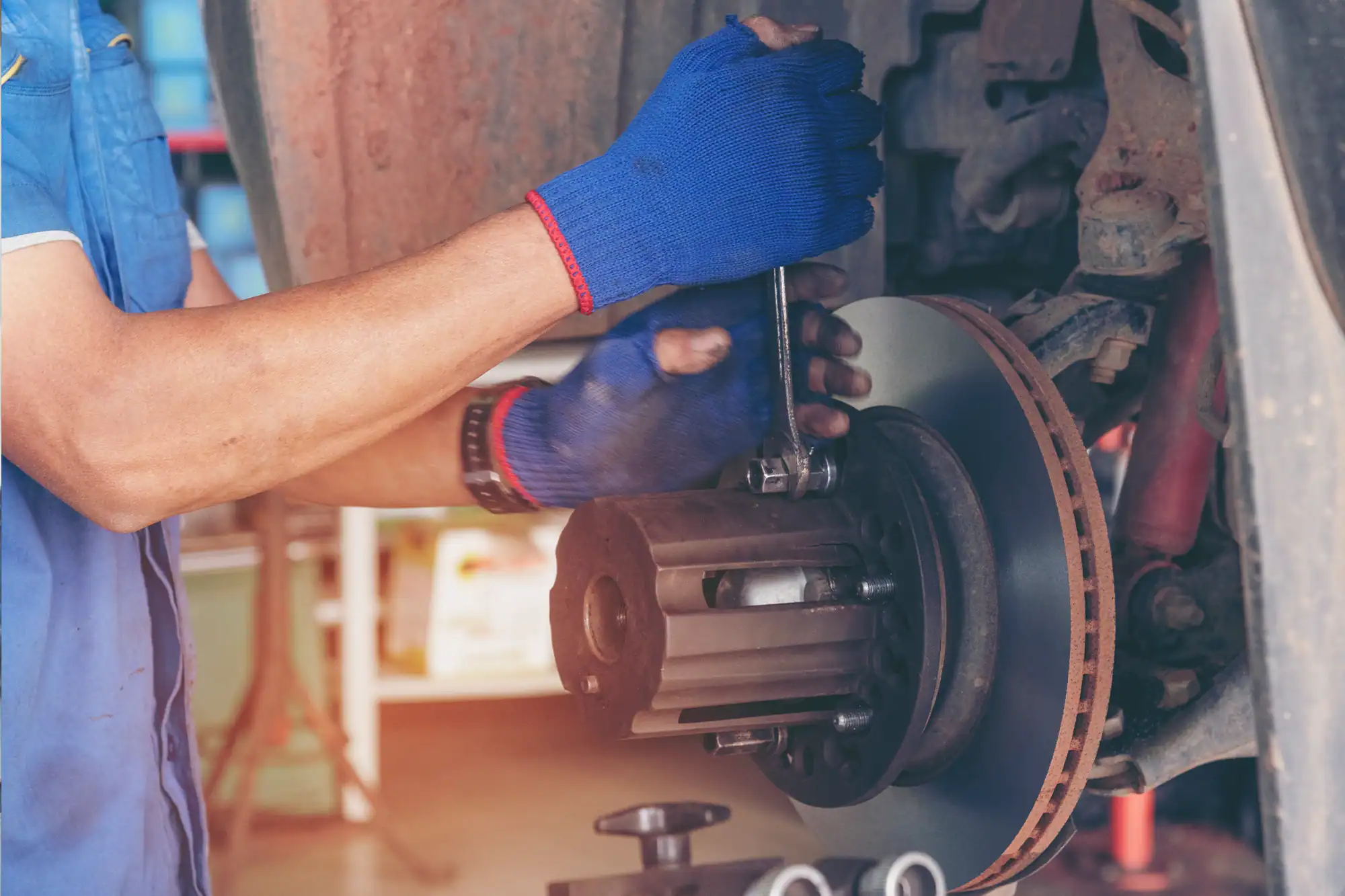 Technician servicing a commercial vehicle brake assembly during fleet maintenance and repair.
